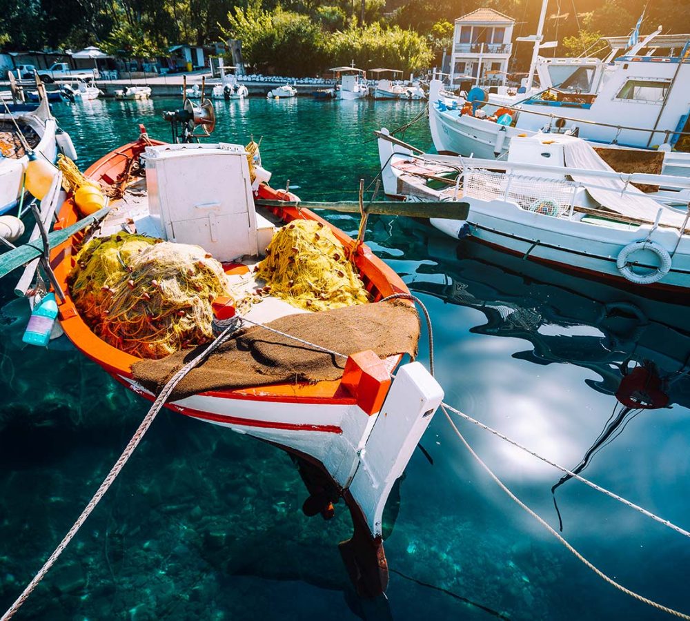 colorful-greek-fishing-boats-in-small-port-harbor-resize.jpg